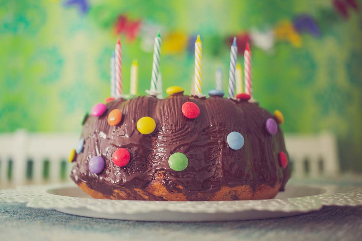 birthday cake chocolate cake with nips and candles in close-up photography dessert